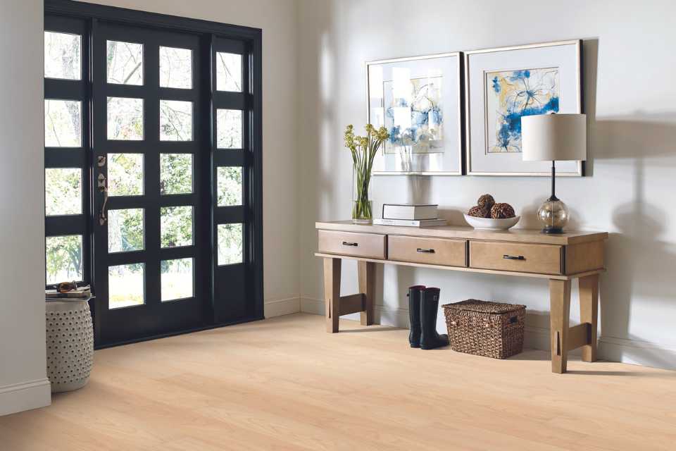 white oak look luxury vinyl in entryway of modern home with artwork and entryway table